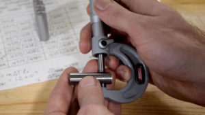 measuring a machined pin with micrometers