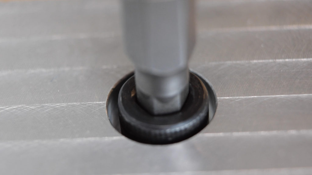 A socket head cap screw being driven into a counterbore with an internal hex driver.